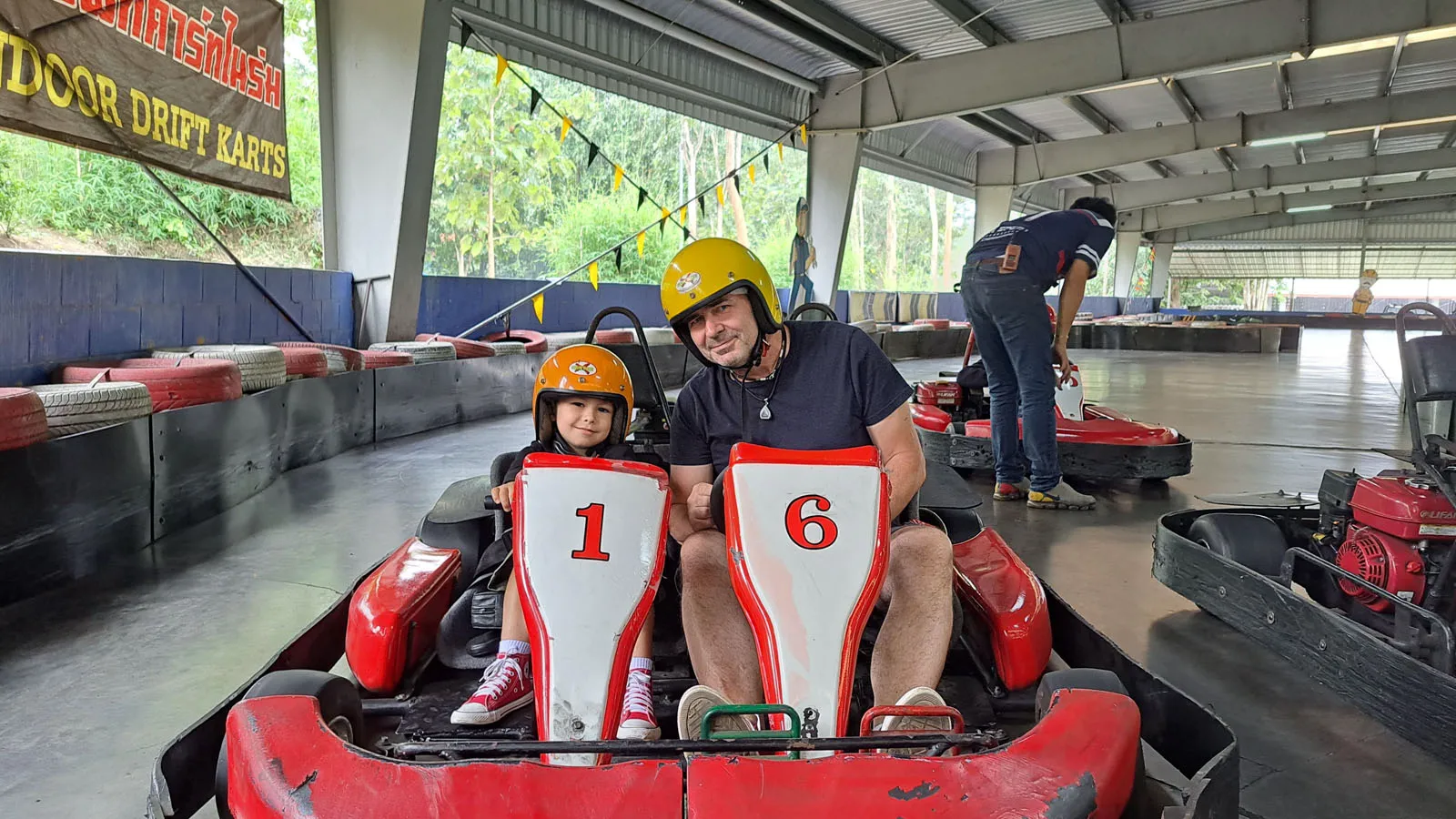 Enea riding in a two-seater go-kart with his dad in Chiang Mai.