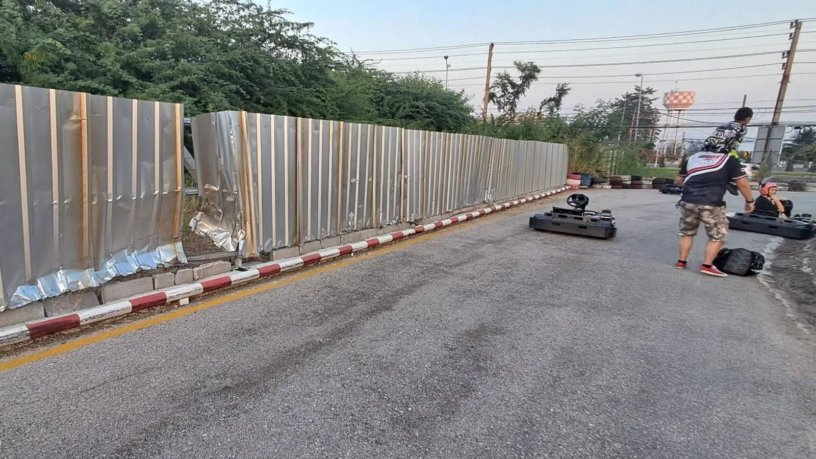 Close-up of the damaged metal wall where Enea’s kart hit during his first crash.